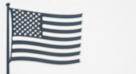 Silhouette of American flag on white background. Copy space.の素材