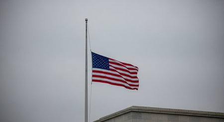 American flag waving in the wind on a cloudy day in Washington DCの素材
