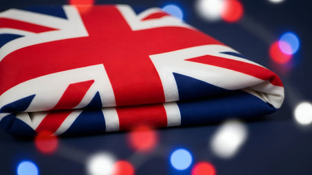 A close-up view of the Union Jack flag, showcasing its vibrant red, white, and blue colors, set against a backdrop of blurred festive lights.の素材
