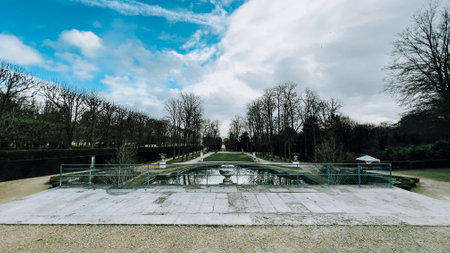 Landscape of the park with pond and green trees in the background. Paris, France