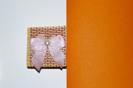 gifts to woman, beautiful gift box abstraction on an orange backgroundの写真素材