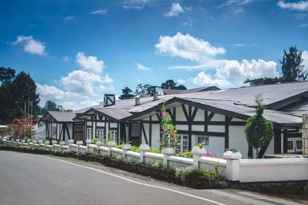 French style one-story wooden white townhouses against bright blue sky. Modern architecture in lovely contryside village. Beautiful classic provencal farmhouse - perfect property to live or invest.の写真素材
