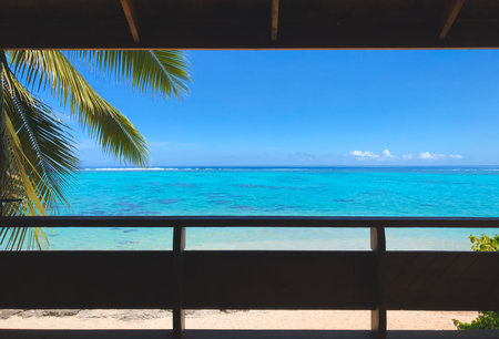 Window to tropical island beach with coconut palm branch, turquoise water and blue sky. Its time to have a vacation concept. Travel tourism backgroundの写真素材