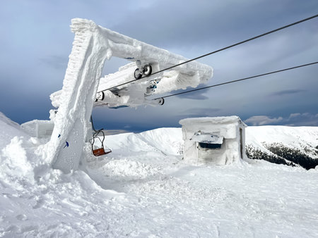 Ski resort chair lift station in high top mountains. Snow weather, frost, ice. Incredible winter landscape. Travel, sport, recreationの写真素材