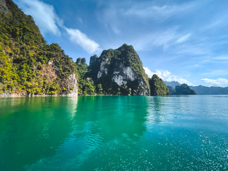 Green water lake in mountains. Amazing natural summer scene. Stunning natural background. Popular touristic destination. Travel, tourism in Cheow Lan Lake - KHAO SOK National Park, Thailandの写真素材