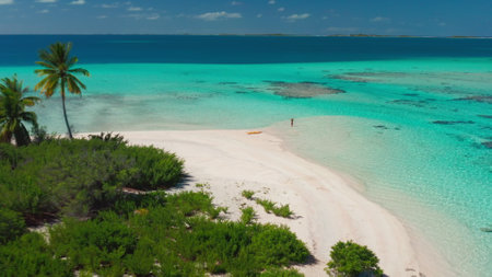 Aerial tropical island beach with coral reef crystal turquoise water. Woman back view standing in sea enjoy beautiful wild nature landscape. Yellow kayak. Summer holiday vacationの写真素材