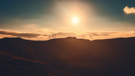 Witness the breathtaking transformation of light as the sun sets over the stunning Carpathian Mountains, casting warm hues across the expansive landscape.の写真素材