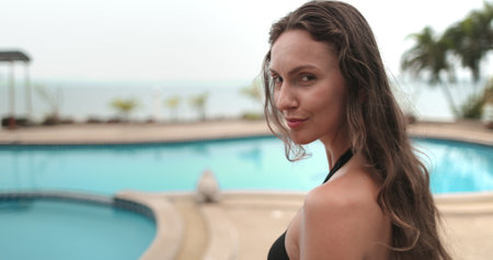 Happy young woman close up with long hair relax walking exotic tropical spa resort swimming pool....