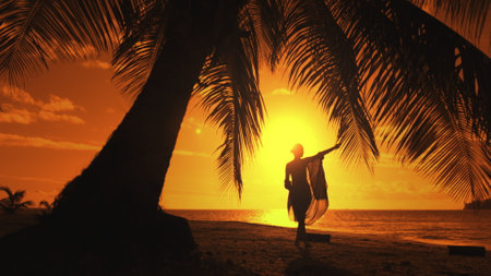 Woman is dancing on a beach at sunset, enjoying the beauty and peace of nature. The image evokes feelings of freedom, joy, and serenityの写真素材