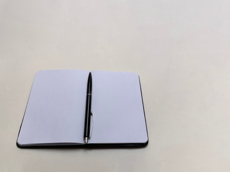 open notepad with black penの写真素材