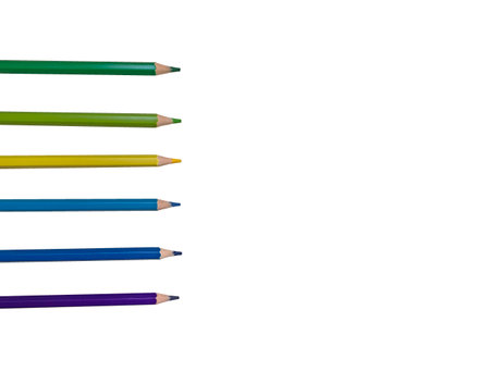 Colored pencils in a row, blue, yellow, purple, green, light green and others. Colored pencils on a white background.の写真素材