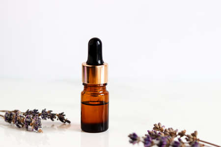 Bottle of lavender essential oil with dropper. Copy space. Beauty and body care concept. Serum skin care product. Selective focusの写真素材