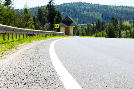 Empty road against blurred background of mountain landscape. Travel and vacation concept. Selective focusの写真素材