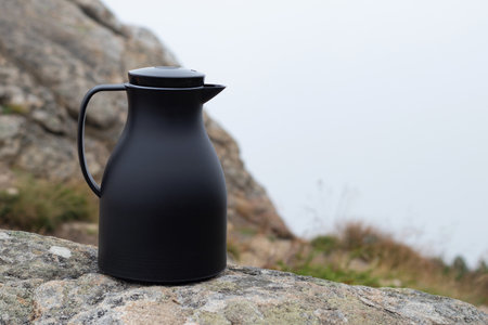 jug on rocks against a mountain landscape. Travel or tourism concept. Outdoors. Selective focus, copy spaceの写真素材