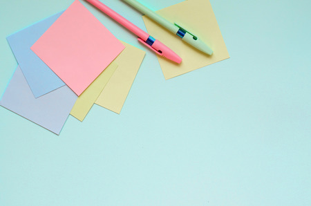 Two pen and stickers lie on a blue background.の写真素材