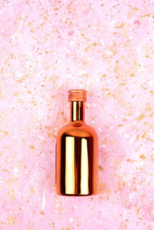 Festive shiny bottle. Abstract photo with a bottle of wine and sequins.の写真素材