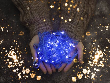 Blue lanterns in his hands. Holiday magic photo.