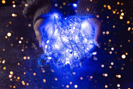 Blue lanterns in his hands. Holiday magic photo.