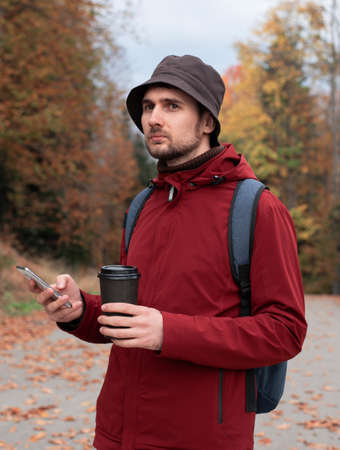 A young man is traveling in the mountains.