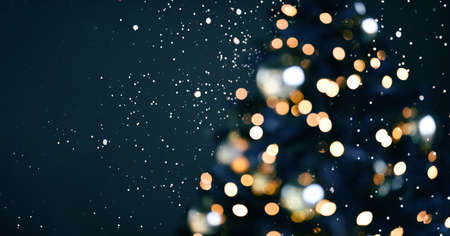 Blurred background. Christmas background with lights. Holiday light bulbs. Blurred silhouette of a...