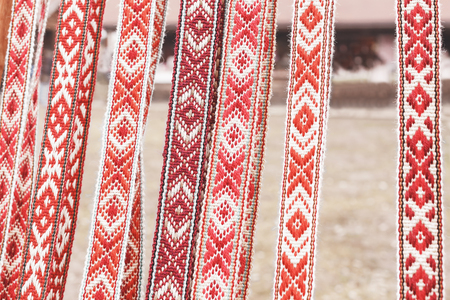 linen belt with ornaments that hang in a row. National belt, handmade. Natural belt sold in the marketの写真素材