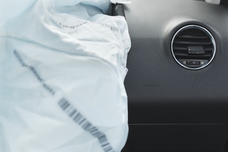 the airbag is fired during the accident. Blue. The inscription airbag and the sticker on the panel.の写真素材