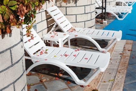 Empty sun loungers at the hotel, with fallen leaves on them. No one, closed the tourist season....