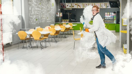 Professor in the chemistry runs out with a smoke and a flask