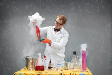 Professor in the lab conducting chemical experimentsの写真素材