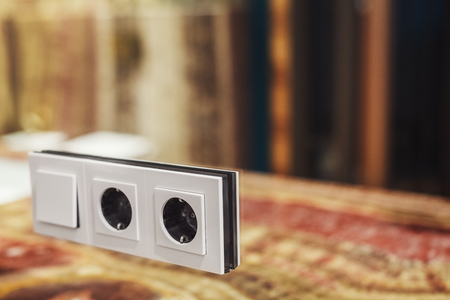 Switch and socket mounted in a mirrored wallの写真素材