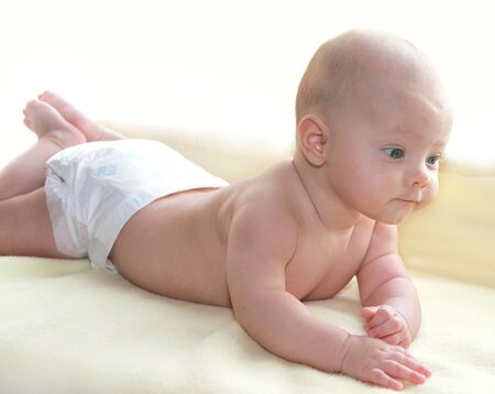 Lying baby girl looking at and thinking isolated