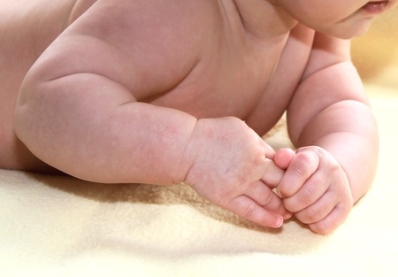 Closeup hands of beautiful little baby girlの写真素材
