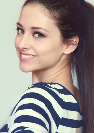 Closeup portrait of smiling girl with long hair isolatedの写真素材