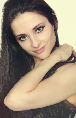 Closeup portrait of beautiful girl with long hair holding the hand on shoulder and sexy lookの写真素材