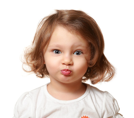 Funny beautiful kid making grimace isolated on whiteの写真素材