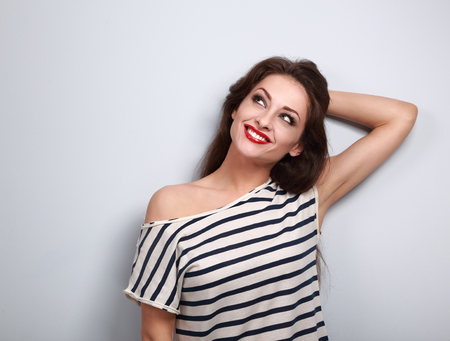 Happy makeup thinking young woman relaxing and looking up. Bright closeup portraitの写真素材
