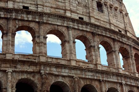 Closeup portrait of Coliseum building old wall with arch in Rome, Italy