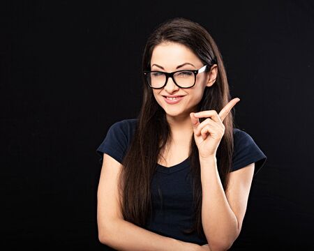 Very concentrated happy business woman in glasses looking up and find the solution on problem situation. Corona virus. Studio portrait on grey background with empty copy spaceの写真素材