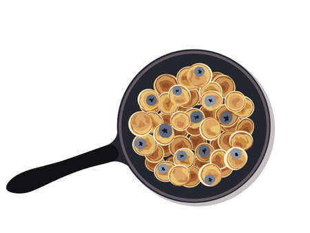 Mini pancake flakes with butter and blueberry for breakfast on the pan. Tiny pancakes, a new food...