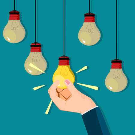 A businessman hand grabs a bright light bulb. Business idea vectorのイラスト素材