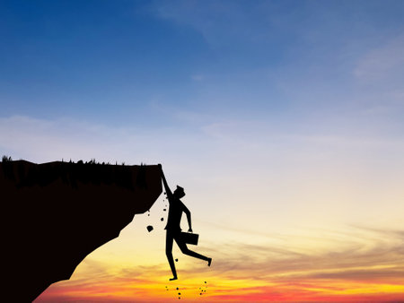 Businessman falls off a cliff, business crisis conceptの写真素材
