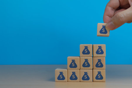 Accumulate wealth, human hand placing money bag icon upの写真素材