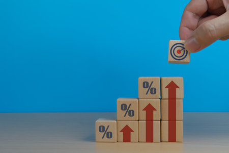 Achieve Goal, Human Hand Places Goal Icon on Growth Graphの写真素材