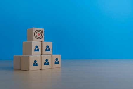 Employees with one goal on wooden blocksの写真素材