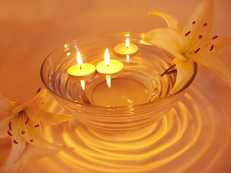 spa lit candles lilies flowers health-care treatmentの写真素材
