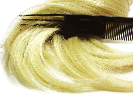 hair brush with long blond hair in itの写真素材