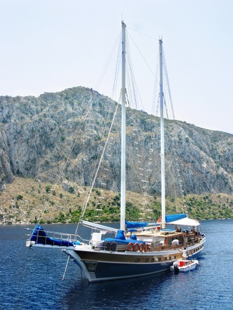yacht in aegean sea cruise among high mountainsの写真素材