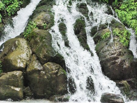 waterfall falling view out of grottoの写真素材
