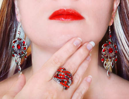 fashion style manicure make-up jewelery ring and earrings on womanの写真素材