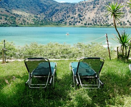 sunbeds relaxation near mountain lake Kournas Greeceの写真素材